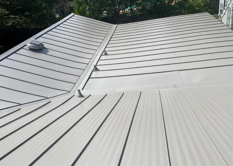 Solar attic fan installed on a metal roof for Roof Ventilation in Kingsbury
